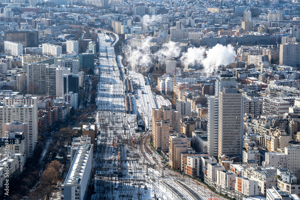 Paris in winter snowy railroad tracks of Montparnasse railway station