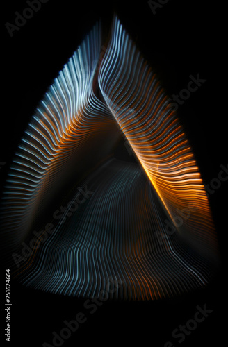 Multicolored twisted ordered parallel lines on a black background. Light in motion. Color abstraction.