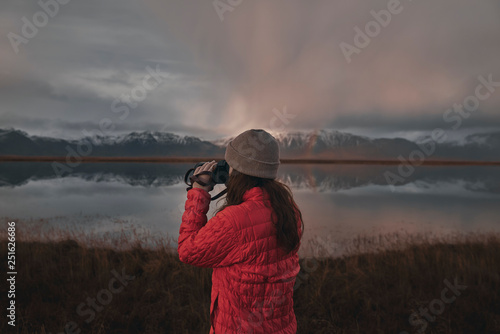 Rear view of woman with binoculars looking at view