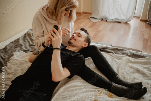 Young couple relaxing on bed at home