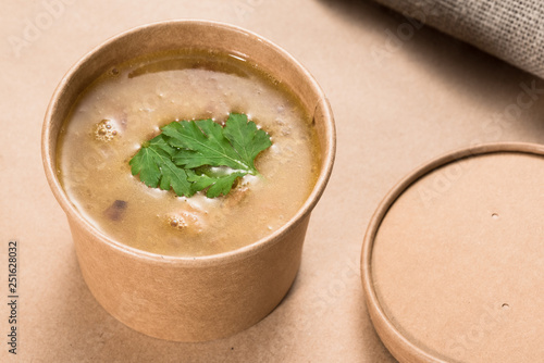 Soup in a disposable cup of craft paper