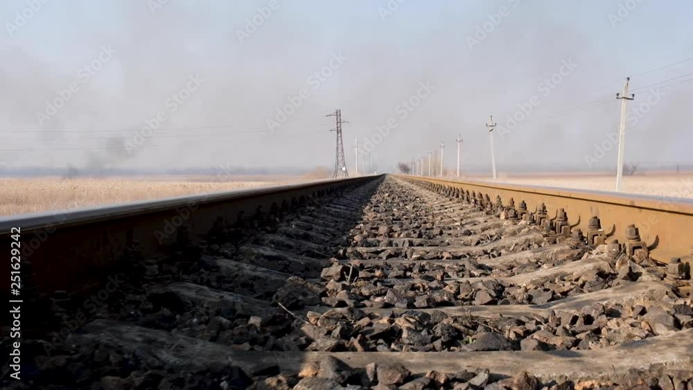 distant view of the iron rails for trains in the middle of the steppe, bottom view, Ukraine
