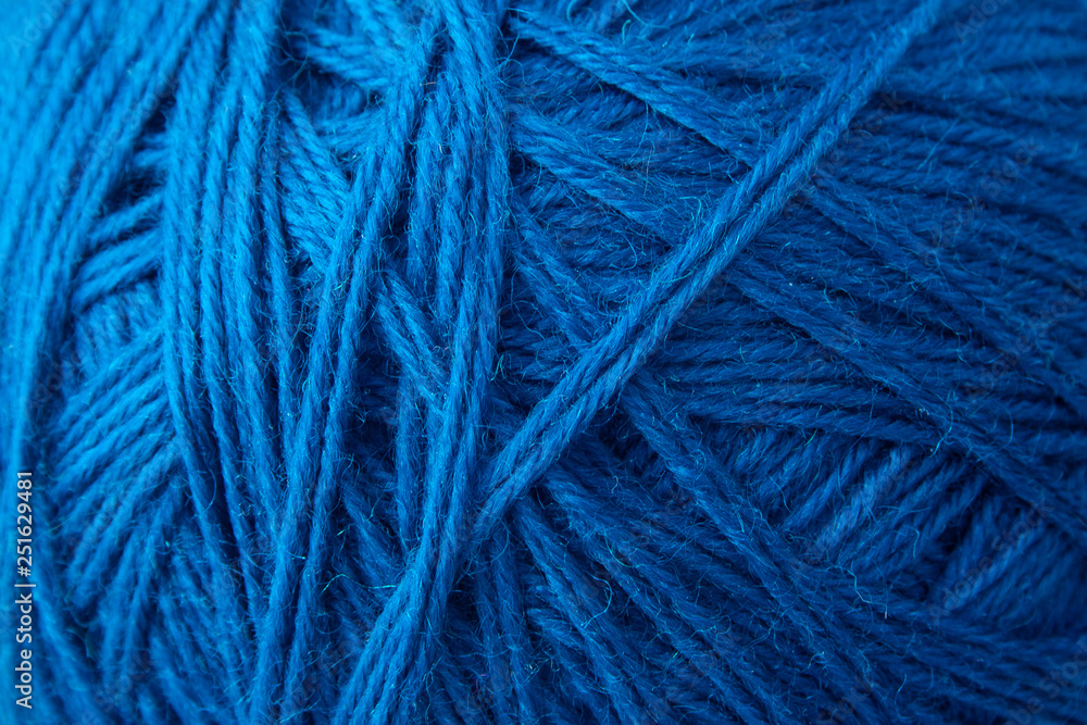 Blue yarn clew close up texture. Blue wool background Blue yarn clew close up texture. Blue wool background