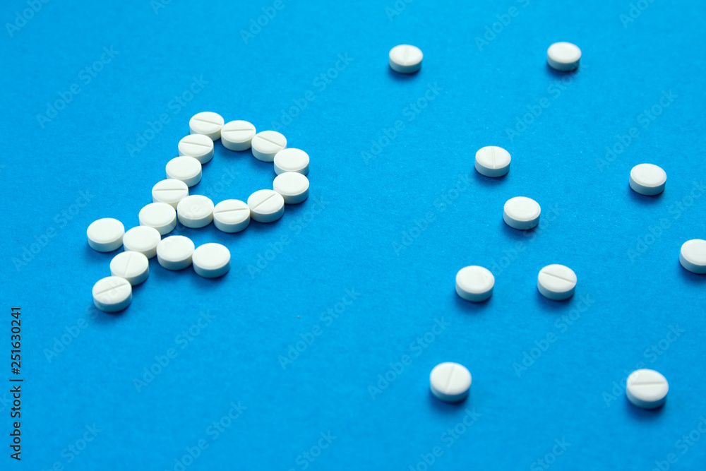 white pills in the shape of a ruble are scattered on a blue background white pills in the shape of a ruble are scattered on a blue background