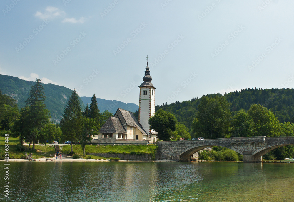 Scenic view of the Church of St. John the Baptist, bridge, Julian Alps and lake, Bohinj, Slovenia