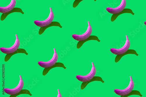 Pattern of yellow bananas with shadows on blue background.