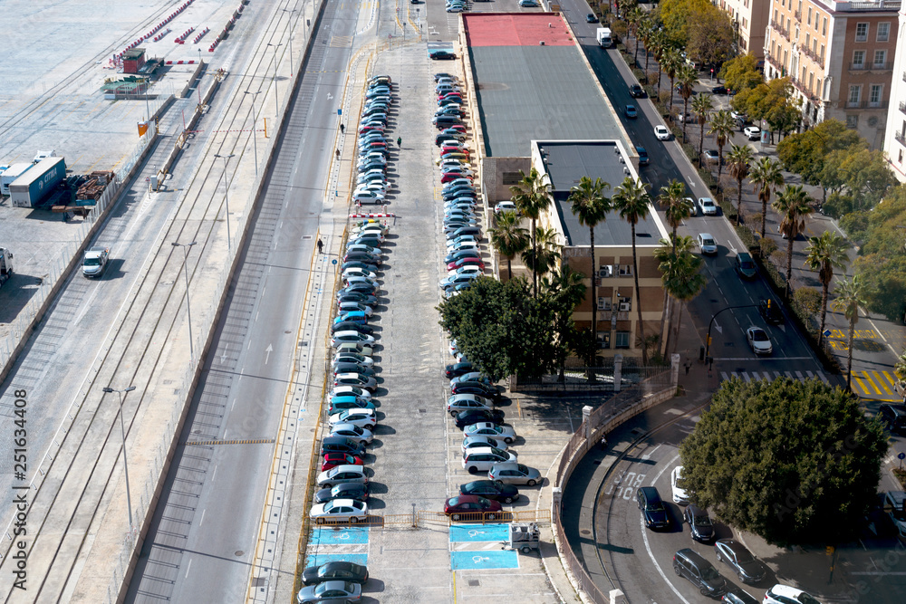 Malaga, Spain, February 2019. Top view of the parking lot, cars, roads. Parking spaces for the disabled.