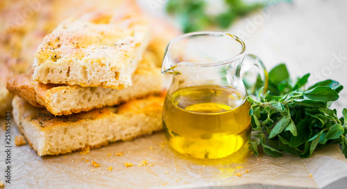 Foccacia bread with oregano herb and olive oil.Fresh italian foccacia bread closeup with mediterranean ingredients photo