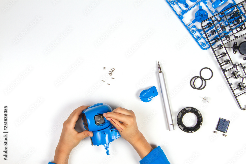 Child hands making blue robot. Robotic, learning, technology, stem education for children background Child hands making blue robot. Robotic, learning, technology, stem education for children background