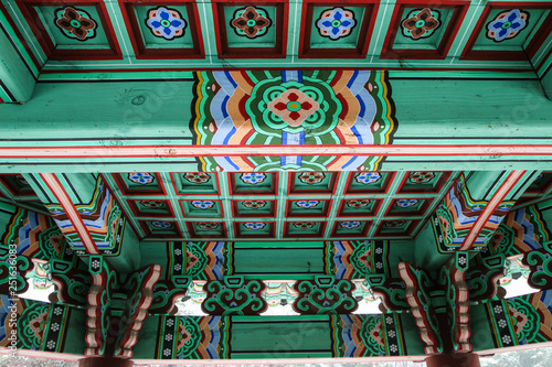 A detail Picture of a traditional wooden roof of a Korean palace. You can see the ornaments and decorations.  © shootingtheworld