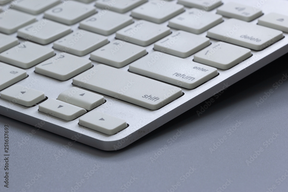 Wireless keyboard on gray background.