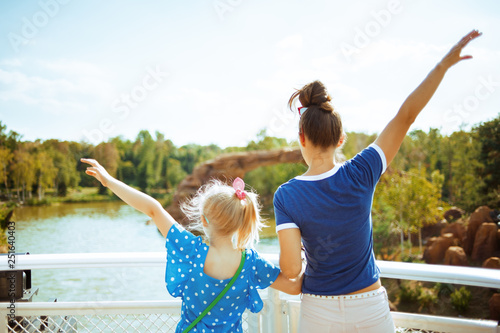 mother and daughter tourists rejoicing while river cruising