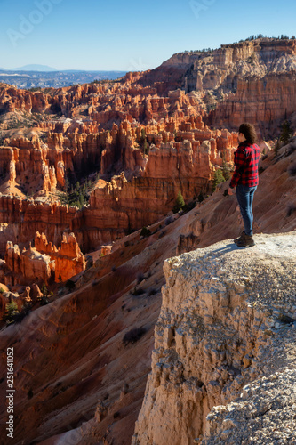 Woman enjoying the Beautiful View of an American landscape during a sunny day. Taken in Bryce Canyon National Park, Utah, United States of America.