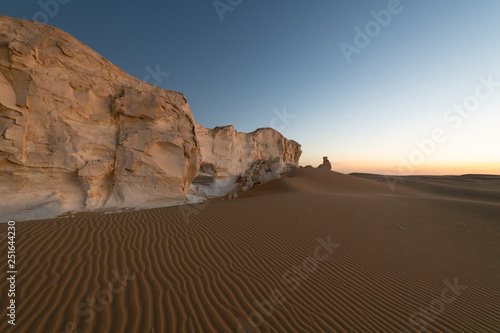 Sunset landscape with chalck rock formations at the White desert national park in Egypt