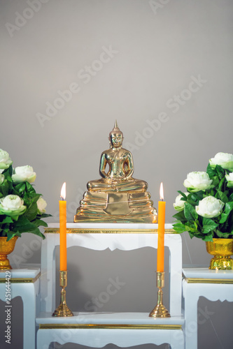 golden buddha statue on white shelf