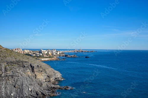 A top-down view with the small village of Cabo de Palos, Spain surrounded by deep blue water in the background.