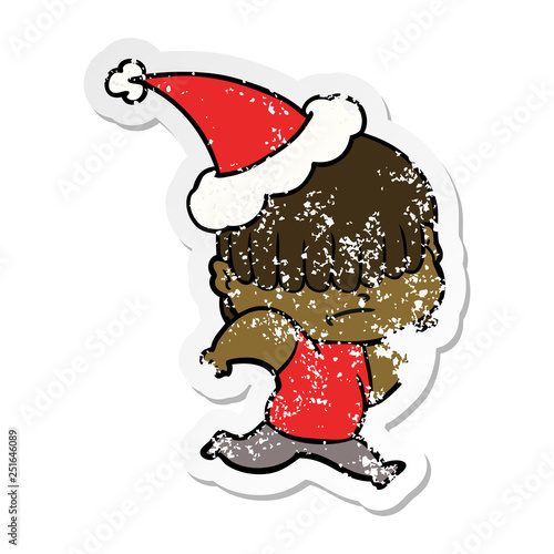 distressed sticker cartoon of a boy with untidy hair wearing santa hat
