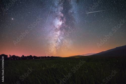 Beautiful night landscape, Green field and milky way galaxy. 