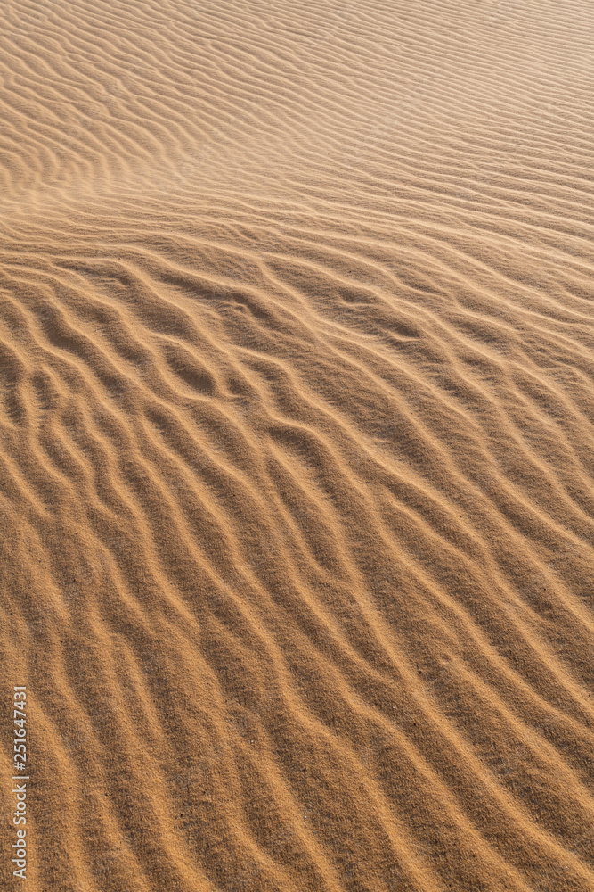 Amazing abstract background image of ripples and waves in the sand at sunrise Amazing abstract background image of ripples and waves in the sand at sunrise