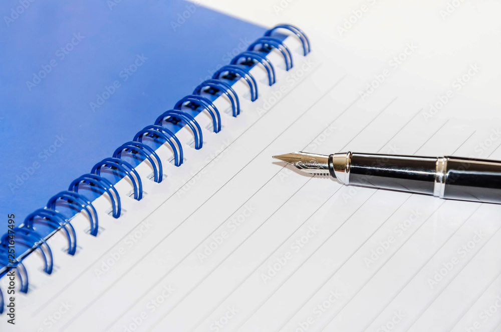 pen and notepad on a white background, close-up pen and notepad on a white background, close-up