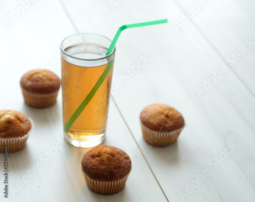 A glass of Apple grapefruit juice and sweet muffins for dessert.Fresh breakfast at the morning. photo