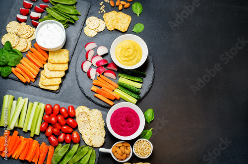 Variation of healthy vegan snacks. Vegetables, crackers, dip and hummus