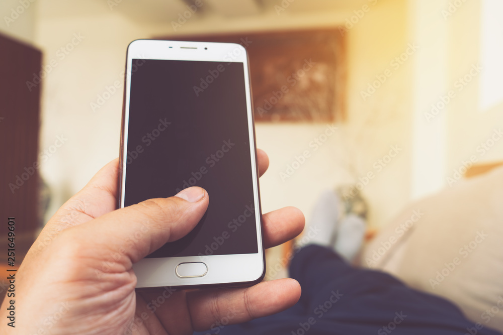 Man using smart phone in room Man using smart phone in room