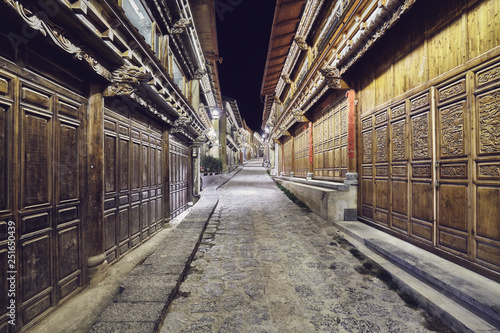 Illuminated empty street of Shangri La Old Town (Dukezong) at night, China.