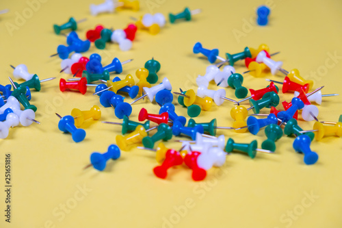 Colorful pins needles on a yellow background!