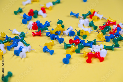 Colorful pins needles on a yellow background!