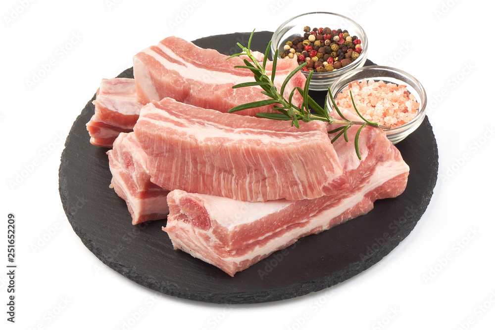 Raw fresh pork ribs with rosemary and spices, close-up, isolated on white background Raw fresh pork ribs with rosemary and spices, close-up, isolated on white background
