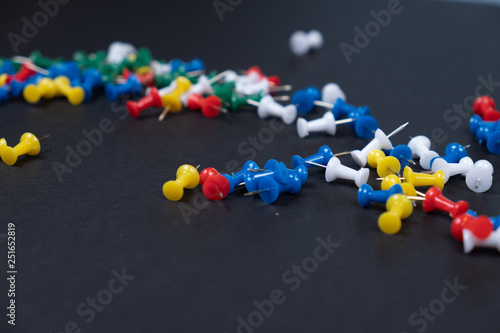 Colorful needles pins in a black background!