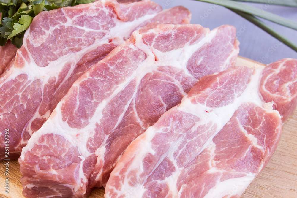 Pork neck steak. Fresh pork with green onions and parsley. Pork neck steak. Fresh pork with green onions and parsley.