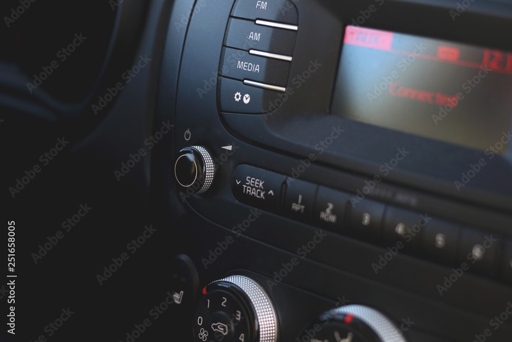 Car audio player system control panel dashboard closeup with buttons and radio tuner