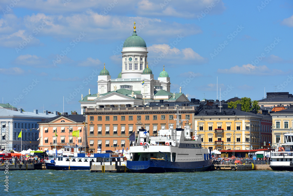 FINLAND, HELSINKI - JULY 18, 2018: South Harbor with ships on background of Evangelical Lutheran cathedral of Diocese