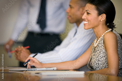 Mid-adult business woman with colleagues in a boardroom. photo