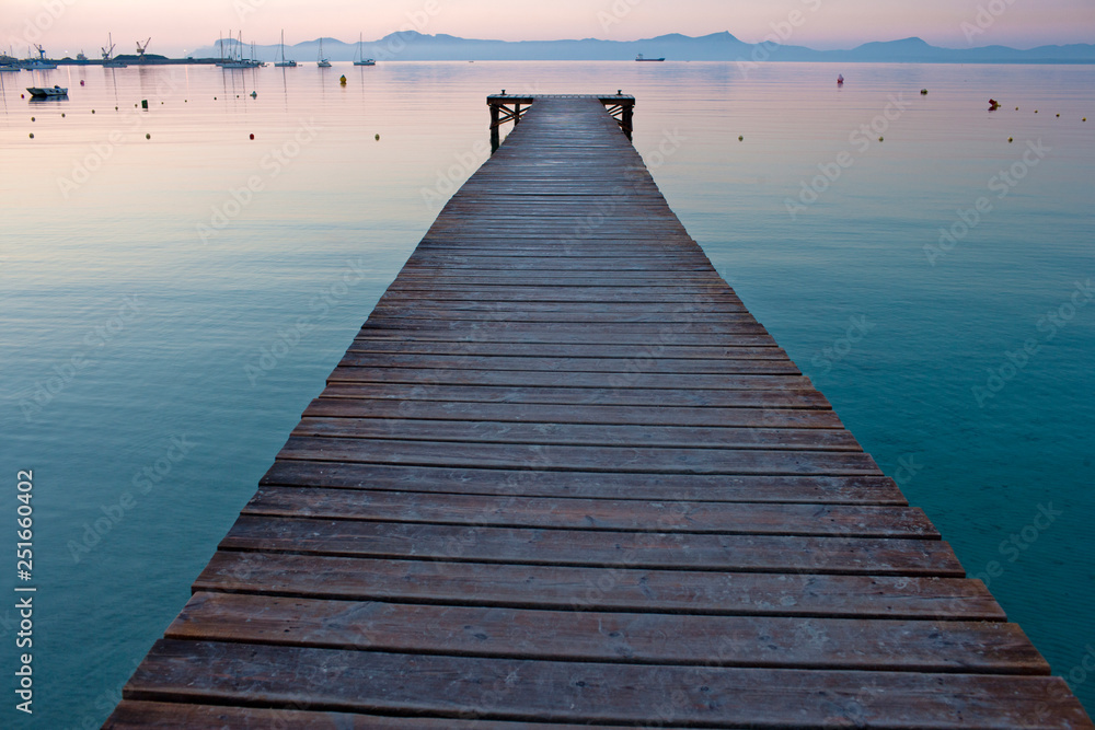 Wooden pier and calm sea at sunset. Wooden pier and calm sea at sunset.