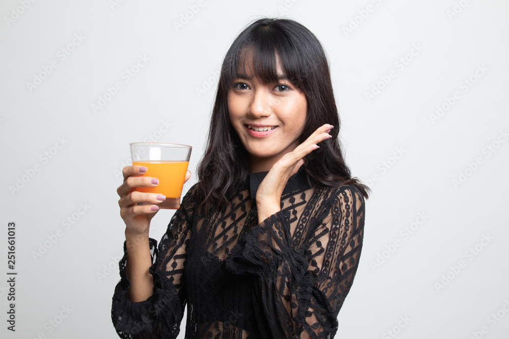 Happy Young Asian woman drink orange juice. Happy Young Asian woman drink orange juice.