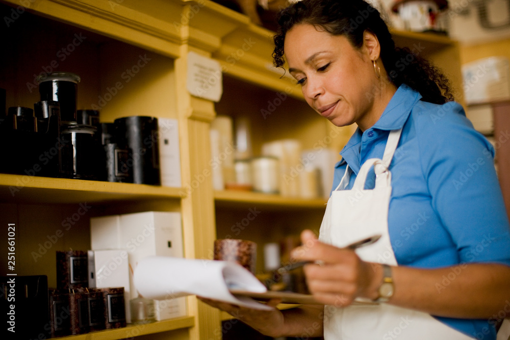 Sales clerk taking inventory in store Sales clerk taking inventory in store