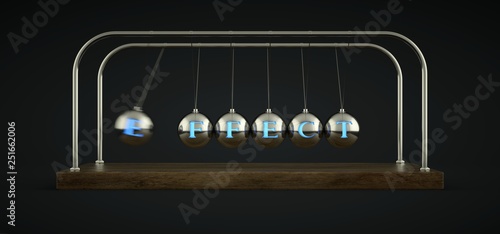 Newton's cradle in motion. With the word Effect written in the spheres. photo