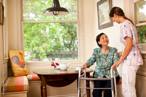 Senior woman receiving a visit at home from her nurse. photo