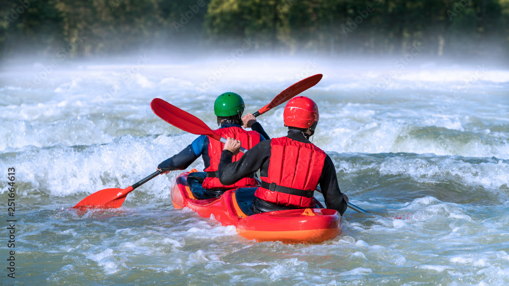 Two people white water rafting in nature