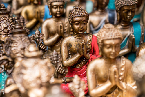 Buddha statue figures sold as a souvenir on a market © Volodymyr Herasymov
