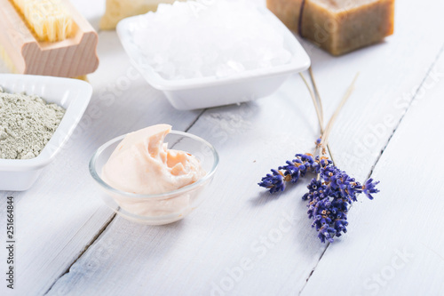 spa products  black mud and clay powder  cosmetic cream  soap  bath salt  shea butter and lavenders on white wood table background