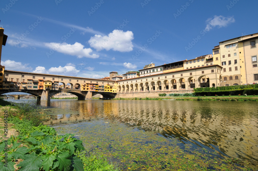 Florence in Italy. Ponte Vecchio on a sunny day. The famous medieval bridge over the Arno river, in Florence, Italy.