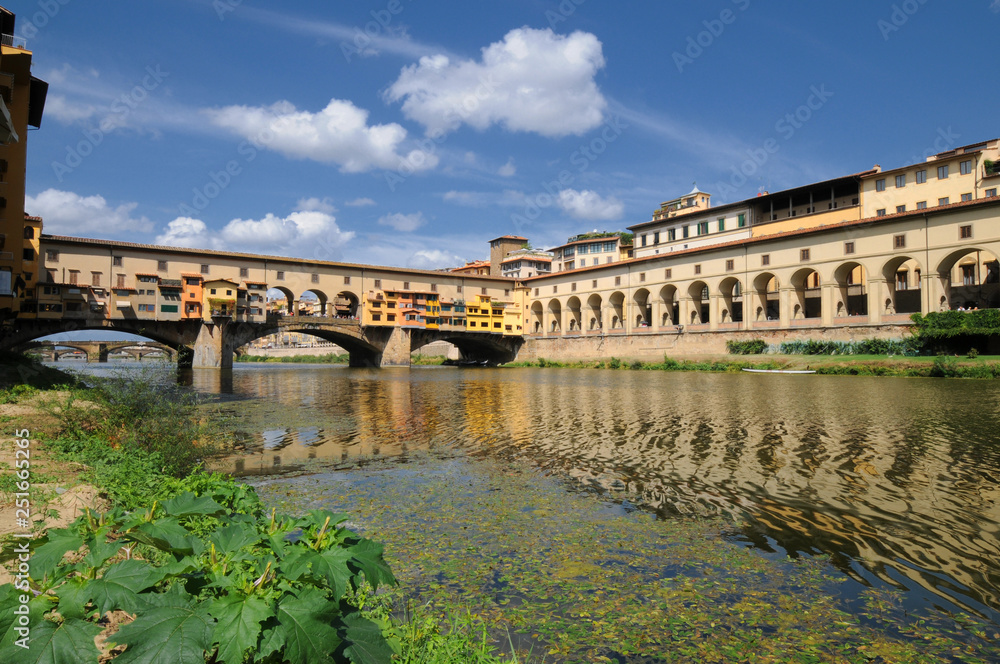 Florence in Italy. Ponte Vecchio on a sunny day. The famous medieval bridge over the Arno river, in Florence, Italy. Florence in Italy. Ponte Vecchio on a sunny day. The famous medieval bridge over the Arno river, in Florence, Italy.
