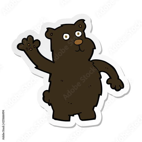 sticker of a cartoon waving black bear