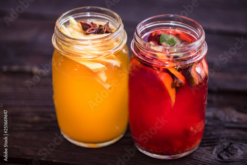 Two glass jars with delicious hot winter beverages close
