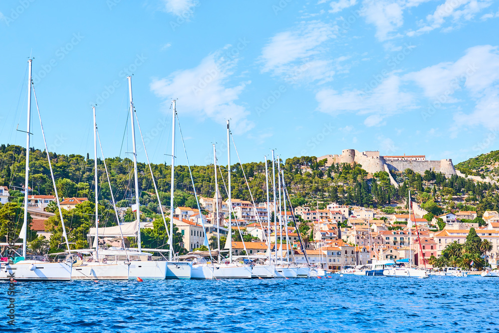 Luxury yachts, ships and fishing boats moored in harbor Hvar, Croatia