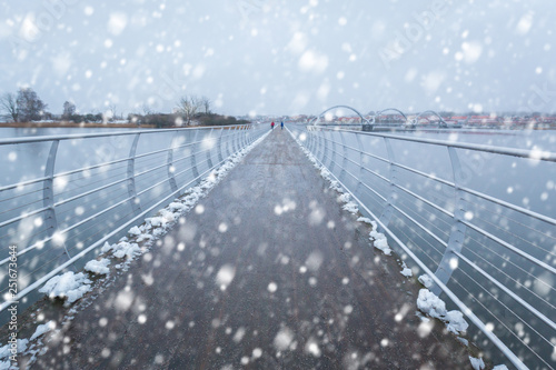 Solvesborgsbron pedestrian bridge with falling snow in the south of Sweden photo